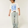 Jean baggy skater délavé clair avec broderie en forme de dés