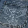Jean skater ample délavé moyen avec motif aigle Jean skater ample délavé moyen avec motif aigle