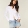 Mini-jupe-short en denim délavé clair à clous Mini-jupe-short en denim délavé clair à clous