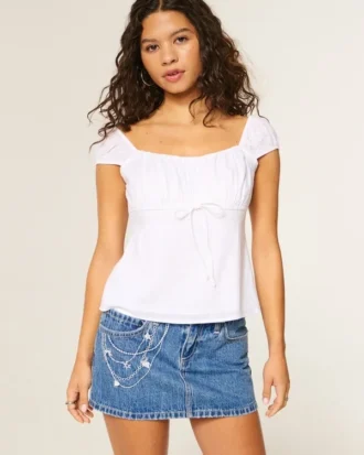 Mini-jupe-short en denim délavé moyen avec broderie en chaîne