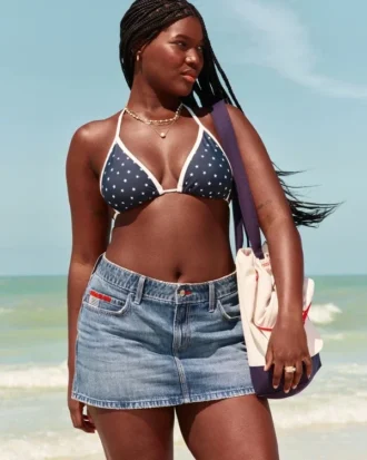 Mini-jupe-short en denim à taille basse, délavage moyen et broderie drapeau