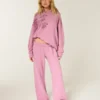 Pantalon de survêtement à jambes larges avec motif rose scintillant Pantalon de survêtement à jambes larges avec motif rose scintillant