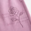 Pantalon de survêtement à jambes larges avec motif rose scintillant Pantalon de survêtement à jambes larges avec motif rose scintillant