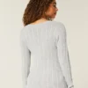Pull iconique à col en V et torsades