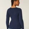 Pull iconique à col en V et torsades